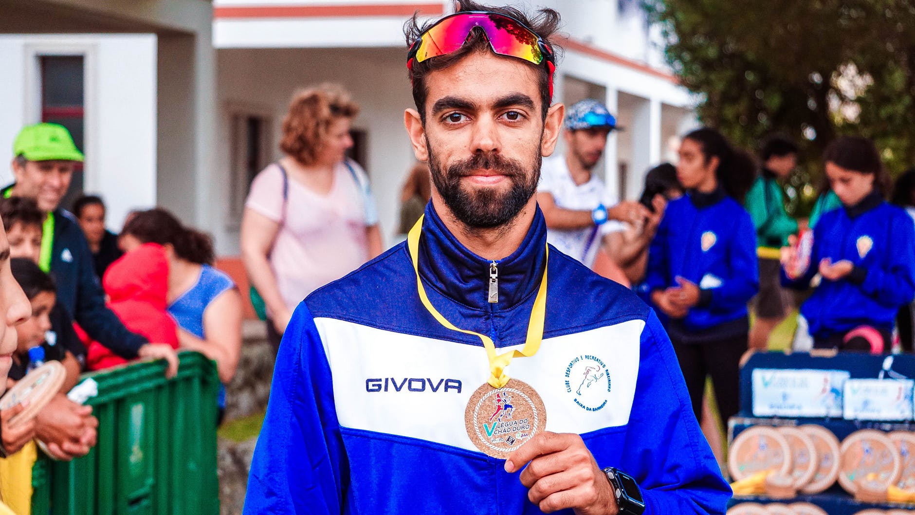 photo of man showing his medal