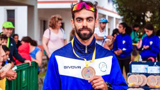 photo of man showing his medal