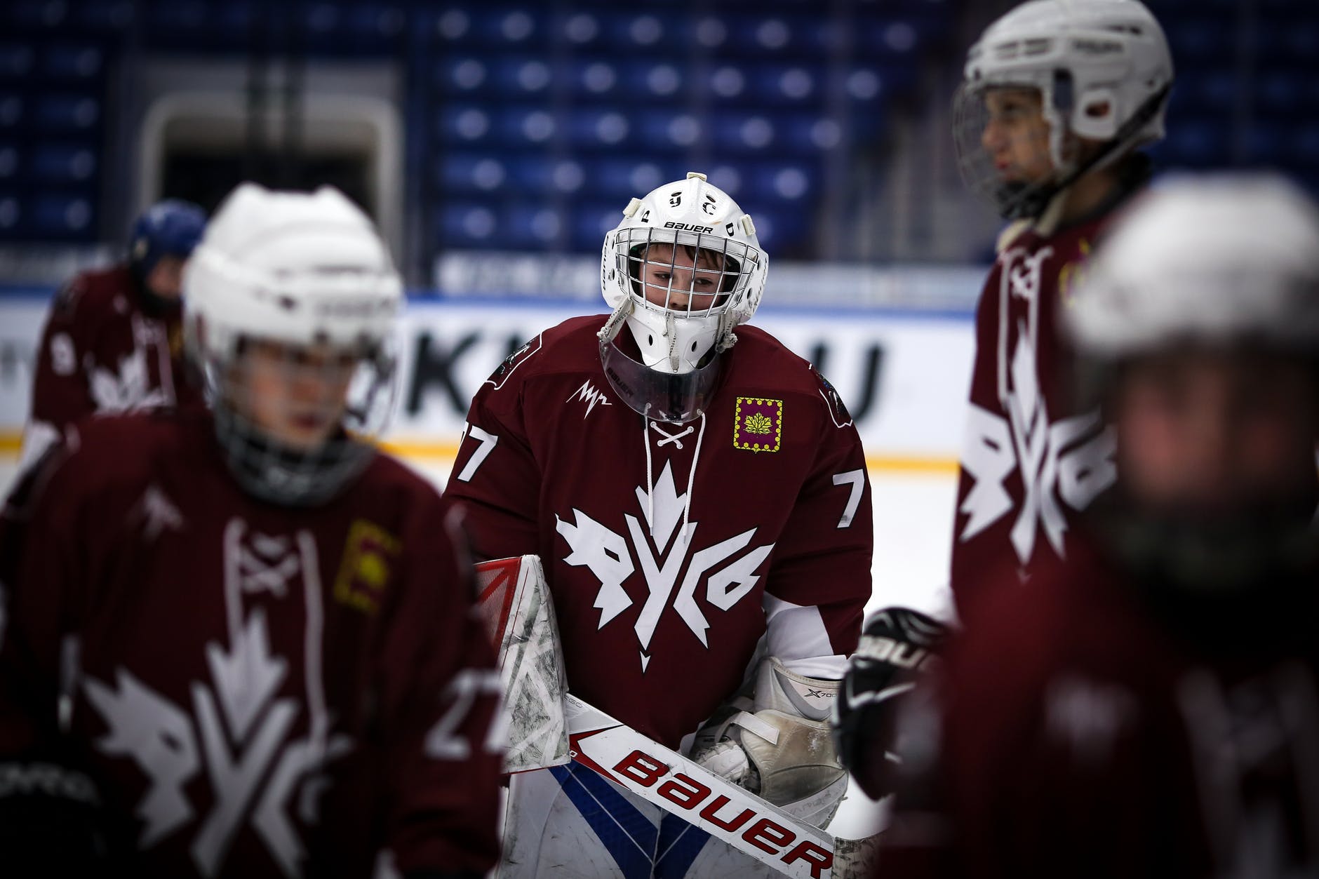 athletes in red and white ice hockey jersey