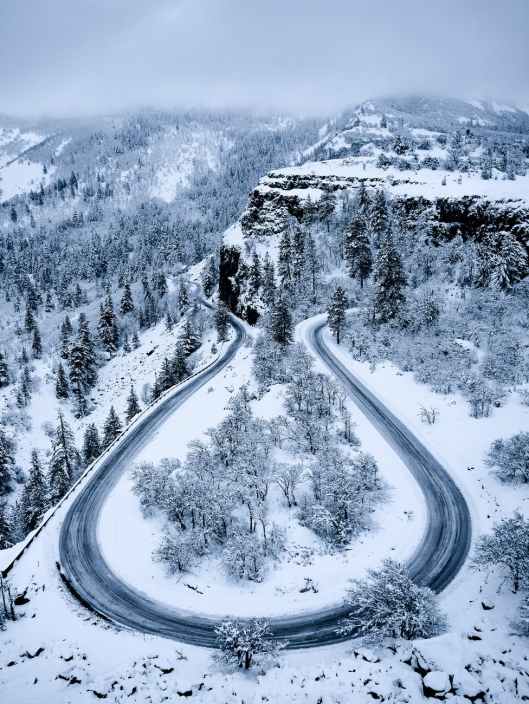 bird s eye view of curved road during winter