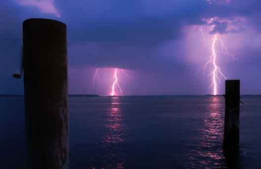 lightning over sea against storm clouds