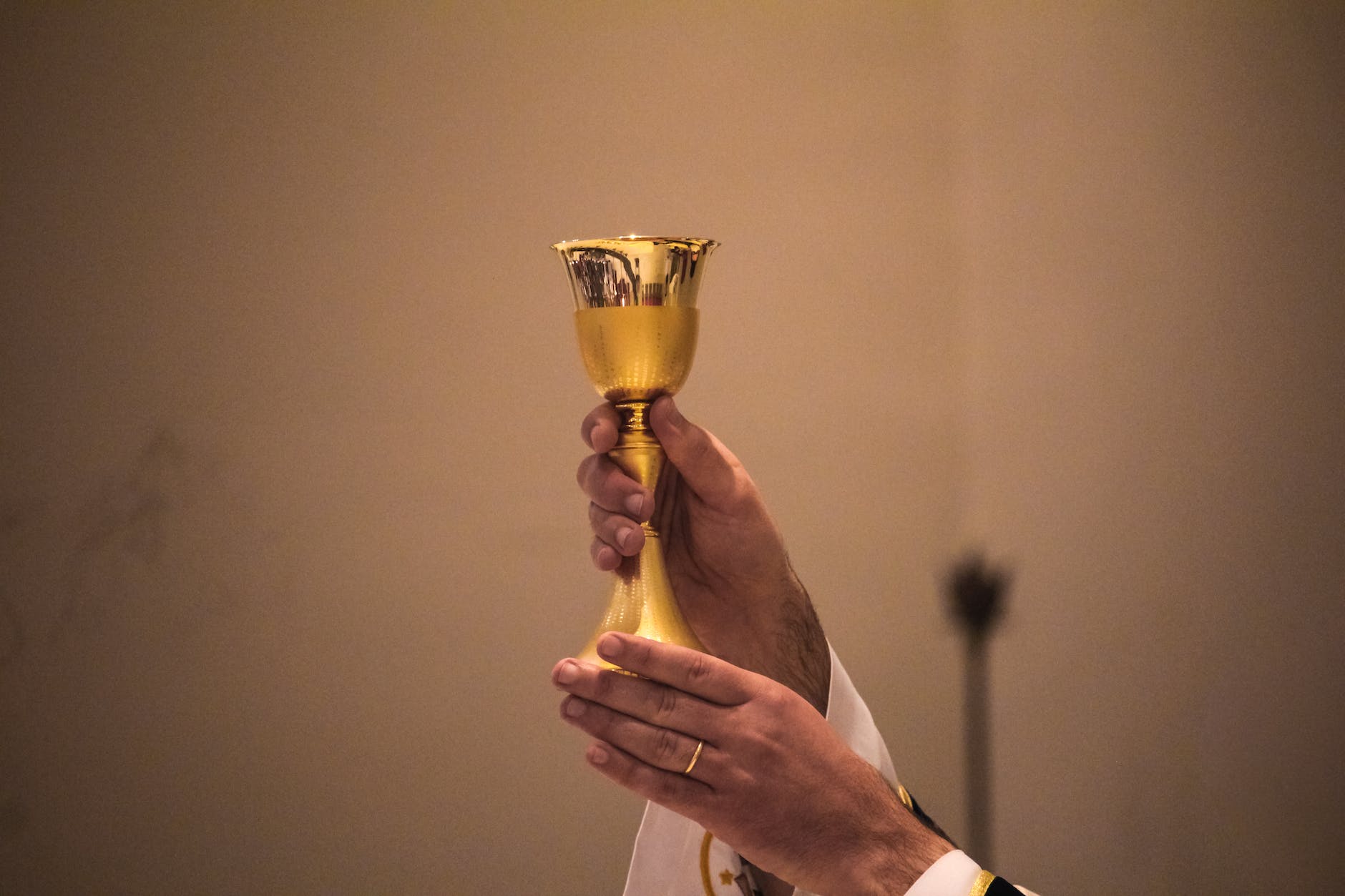 a person holding a chalice
