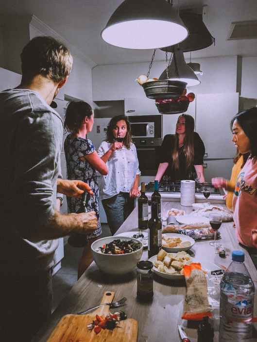 men and women standing infront of dining table