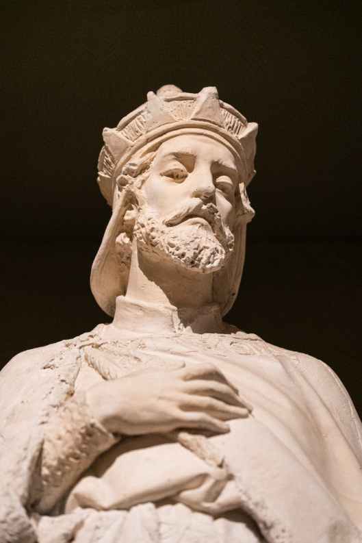 marble sculpture of king on black backg