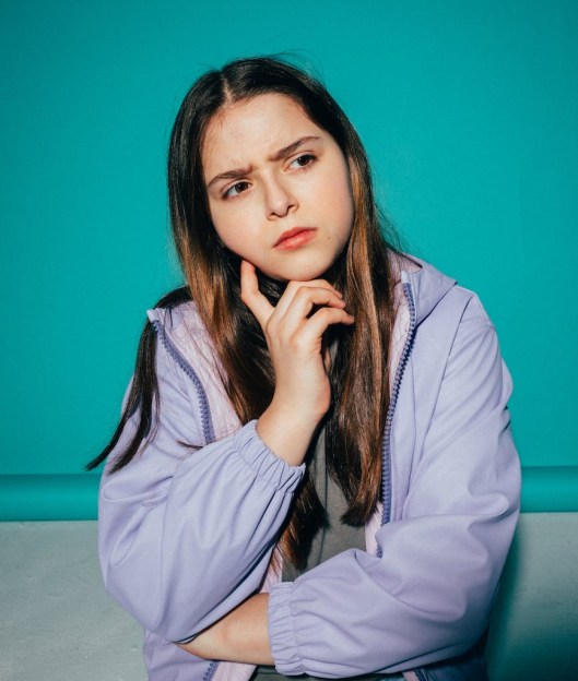 girl wearing a jacket thinking